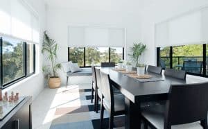 Modern Canberra living room with custom-made blinds next to a window, showing a practical room‑by‑room style that works well in Canberra homes