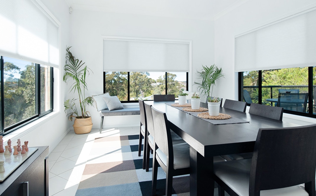 Modern Canberra living room with custom-made blinds next to a window, showing a practical room‑by‑room style that works well in Canberra homes